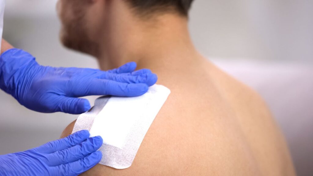 A shoulder wound being cared for.